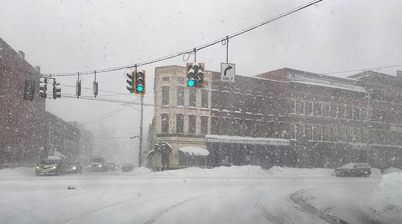 Fresh snow blows through an intersection in Lowville, N.Y., on Thursday, Jan. 22, 2026. (AP Photo/Cara Anna)
