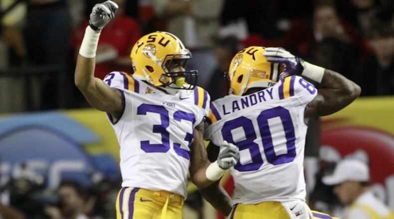 FILE - In this Dec. 3, 2011, file photo, LSU wide receiver Odell Beckham (33) and Jarvis Landry(80) react to an LSU touchdown during the second half of the Southeastern Conference championship NCAA college football game against Georgia, in Atlanta. Former LSU teammates Odell Beckham Jr. and Jarvis Landry are two of the NFL's best young receivers, and they'll play each other for the first time Monday, Dec. 14, 2015, when the Giants visit the Dolphins.. (AP Photo/John Bazemore)