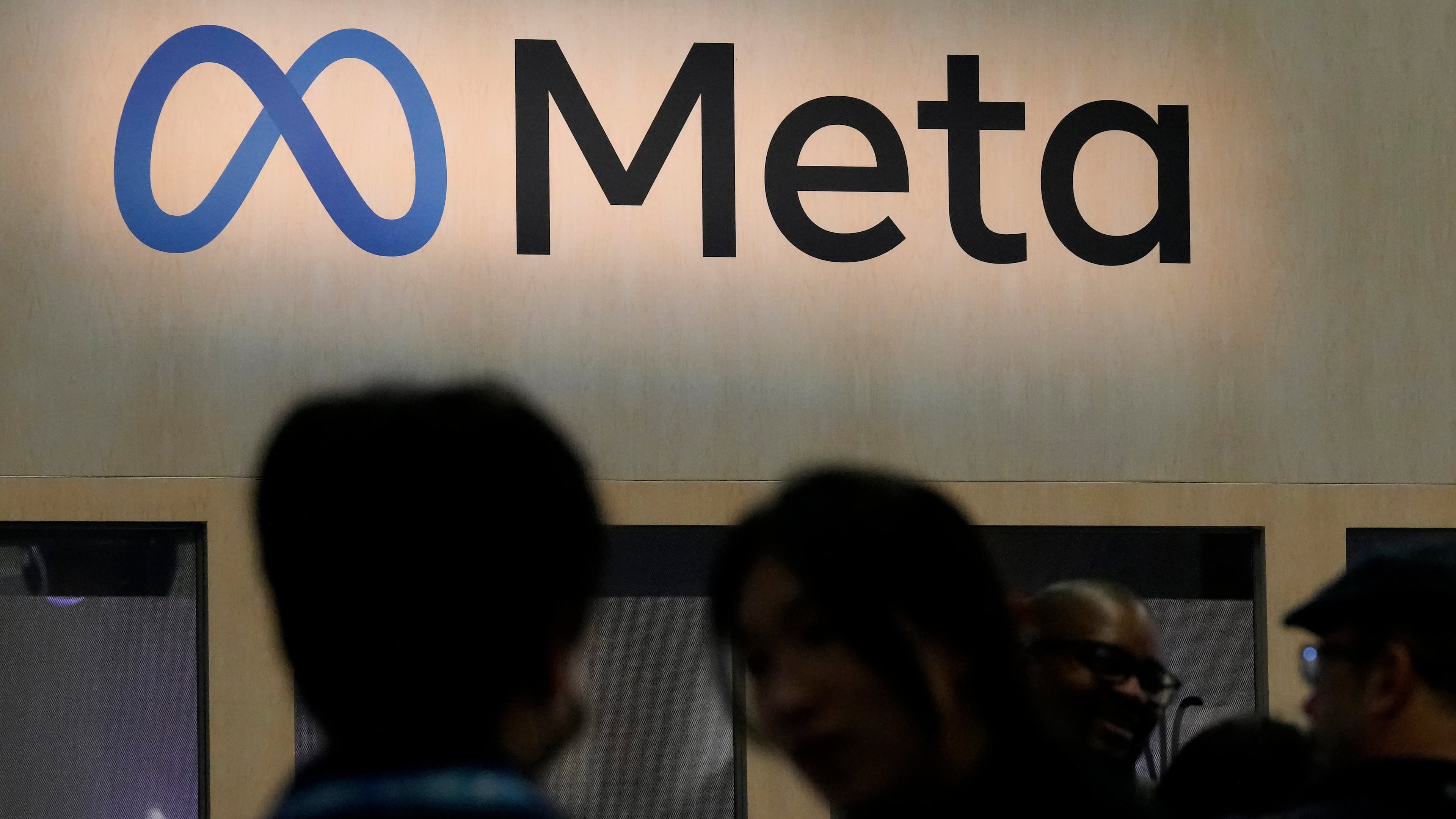 FILE - Attendees visit the Meta booth at the Game Developers Conference 2023 in San Francisco on March 22, 2023. (AP Photo/Jeff Chiu, File)