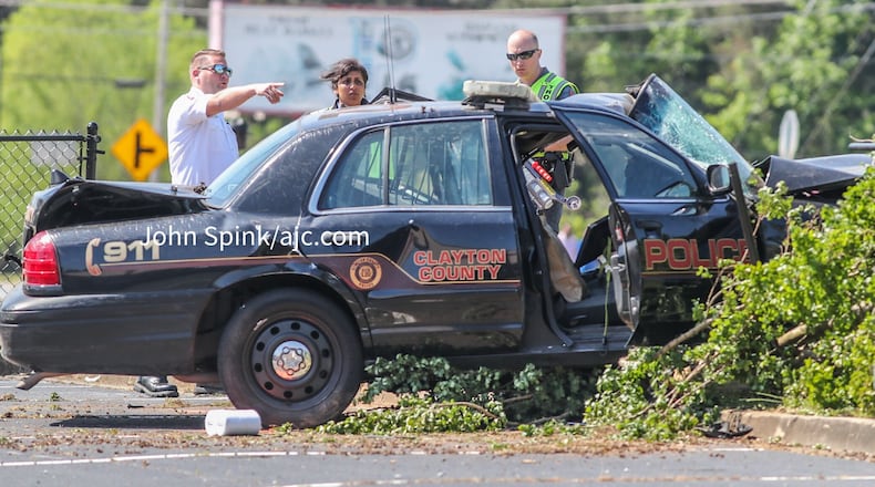 The officer's damaged patrol car ended up in a parking lot.