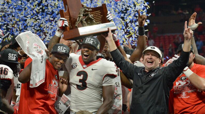 December 2, 2017 Atlanta: Georgia Bulldogs linebacker Roquan Smith (3), head coach Kirby Smart, and Georgia teammates celebrate after defeating the Auburn Tigers 28-7 during the Southeastern Conference championship NCAA college football game at Mercedes-Benz Stadium, December 2, 2017, in Atlanta. Hyosub Shin / hshin@ajc.com