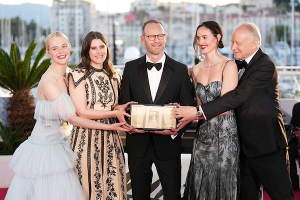 Director Joachim Trier, centre, winner of the grand prix for the film 'Sentimental Value', poses with Elle Fanning, from left, Inga Ibsdotter Lilleaas, Renate Reinsve and Stellan Skarsgard at the awards ceremony photo call at the 78th international film festival, Cannes, southern France, Saturday, May 24, 2025. (Photo by Scott A Garfitt/Invision/AP)