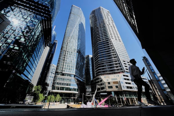 A man walks up to the entrance of a bank in Frankfurt, Germany, Monday, May 19, 2025. (AP Photo/Michael Probst)