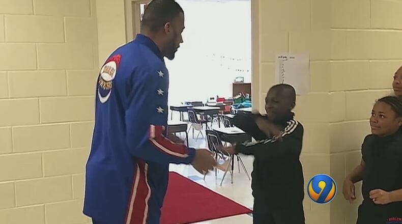 Zeus, a player with the Harlem Globetrotters, greeted Charlotte elementary school students as they entered class.