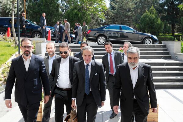 In this photo, released by the Atomic Energy Organisation of Iran, International Atomic Energy Agency (IAEA) Director General, Rafael Mariano Grossi, front center, arrives at Atomic Energy Organisation of Iran, in Tehran, Iran, Thursday, April 17, 2025. (Atomic Energy Organisation of Iran via AP)