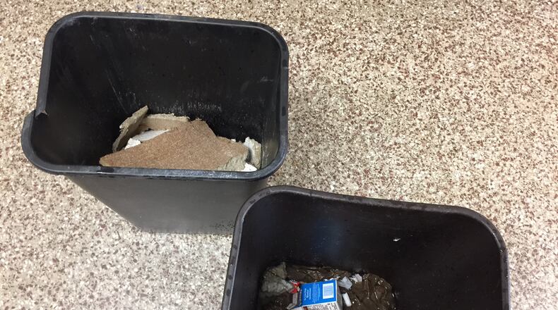 A garbage can was repositioned to collect water dripping from the ceiling in a hallway at Dresden Elementary School. (HANDOUT PHOTO)