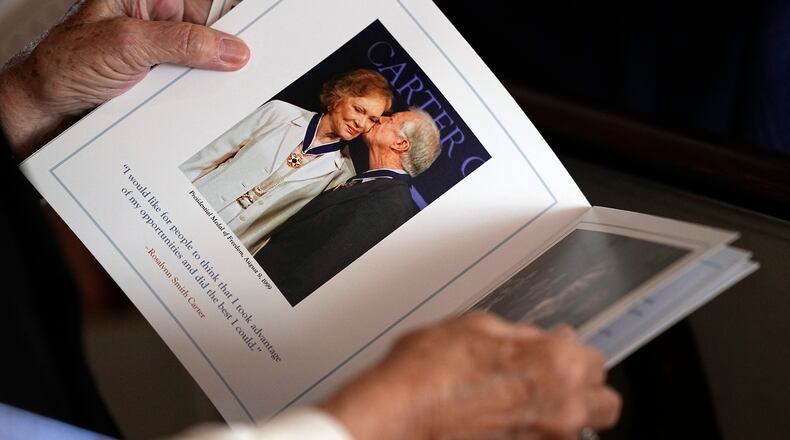 A guest looks at the program before a tribute service for former first lady Rosalynn Carter at Glenn Memorial Church at Emory University on Tuesday, Nov. 28, 2023, in Atlanta. (Brynn Anderson/Pool/AFP/Getty Images/TNS)