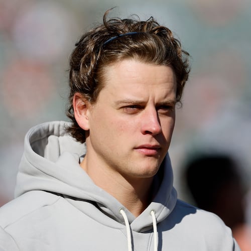 Injured Cincinnati Bengals quarterback Joe Burrow walks on the field before an NFL football game against the New England Patriots, Sunday, Nov. 23, 2025, in Cincinnati. (AP Photo/Jay LaPrete)