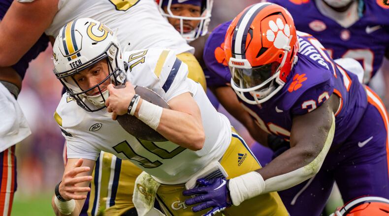 Georgia Tech quarterback Haynes King (10) dives in for a touchdown while defended by Clemson defensive tackle Ruke Orhorhoro (33) during the first half of an NCAA college football game Saturday, Nov. 11, 2023, in Clemson, S.C. (AP Photo/Jacob Kupferman)