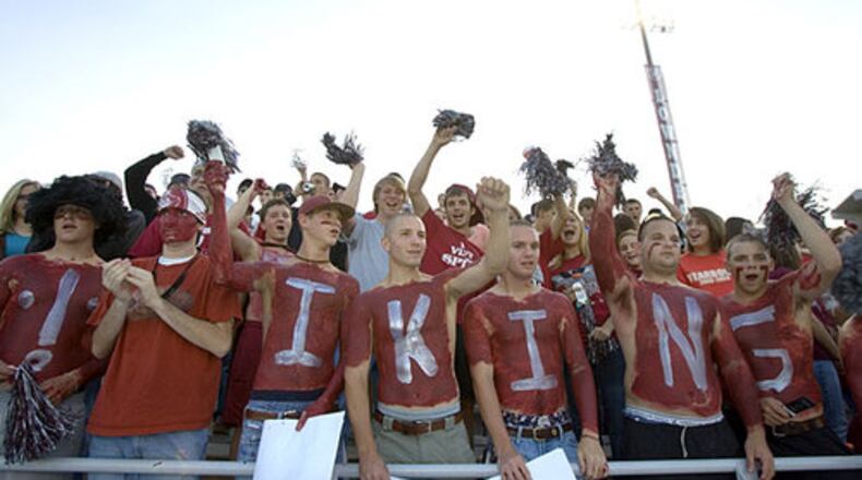 Lowndes High School student fans cheer and jeer as players take the field for warm-ups before a game.