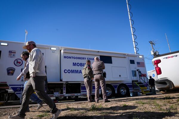 Officials work at a staging area at Olde Security Square Flea Market to respond to a growing wildfire near Cleveland, Texas, Thursday, March 20, 2025. ( Jon Shapley/Houston Chronicle via AP)