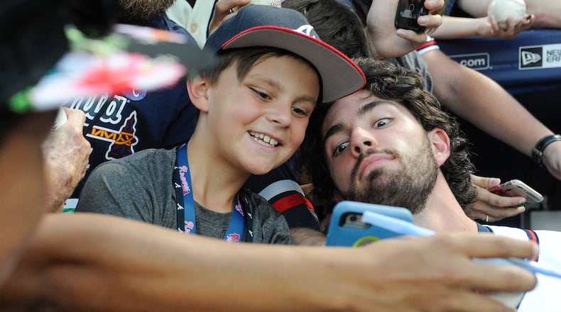 Atlanta Braves' Dansby Swanson, right, poses with 9 year old fan Caleb Zurawick of Chattanooga, Tenn., before a baseball game against the Philadelphia Phillies, Wednesday, Sept. 28, 2016, in Atlanta. (AP Photo/John Amis)