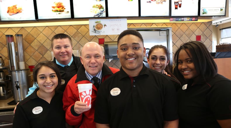 Chick-fil-A CEO Dan Cathy (in red jacket) with employees from one of the chain’s locations in Fairburn.