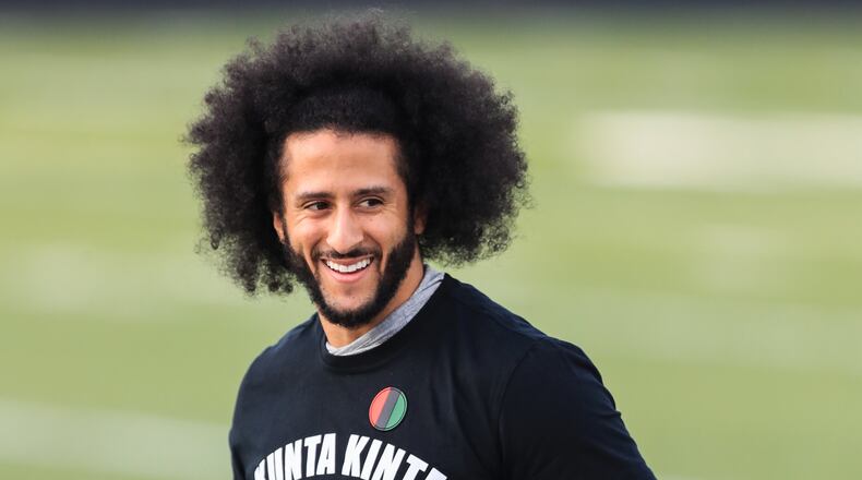 Colin Kaepernick looks on during a private NFL workout Saturday at Charles Drew High School in Riverdale.