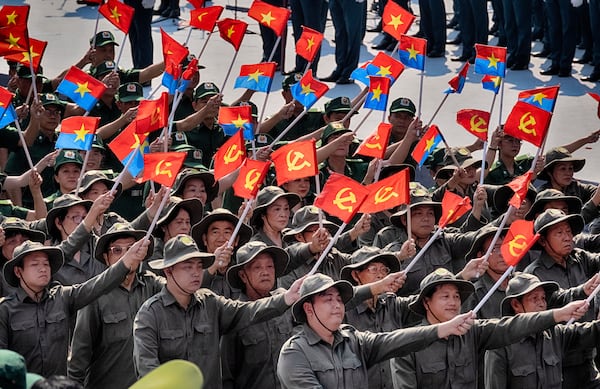 A Vietnamese military unit waves Vietnamese and hammer and sickle flags during a parade celebrating the 50th anniversary of the end of the Vietnam War on Wednesday, April 30, 2025, in Ho Chi Minh City, Vietnam. (AP Photo/Richard Vogel)