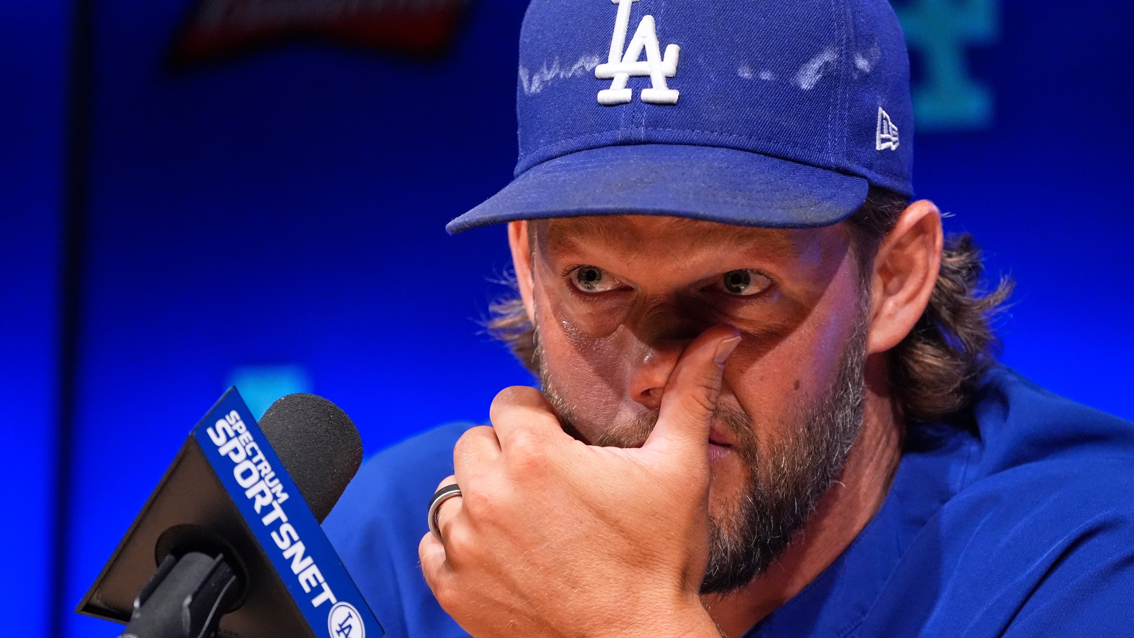 Los Angeles Dodgers pitcher Clayton Kershaw wipes his face as he speaks to the media after announcing his retirement at the end of the season prior to a baseball game against the Philadelphia Phillies Thursday, Sept. 18, 2025, in Los Angeles. (AP Photo/Mark J. Terrill)