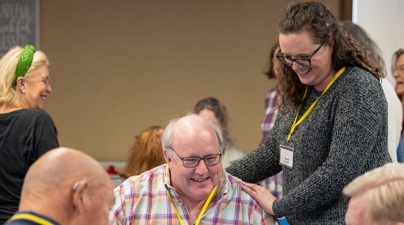 Member Doug Jones (who agreed to be photographed) jokes with Executive Director Jenna Smith while working on an art project during a Respite Care Atlanta meeting at Second-Ponce de Leon Baptist Church in Atlanta in 2022. (Phil Skinner for the AJC)