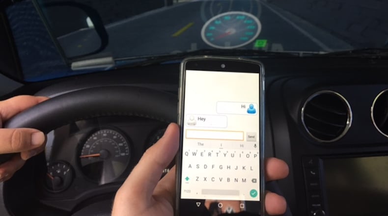 Doug Turnbull gets set to text and drive in Allstate’s simulator ON Aug. 28 in Downtown Atlanta. Doug Turnbull for the AJC