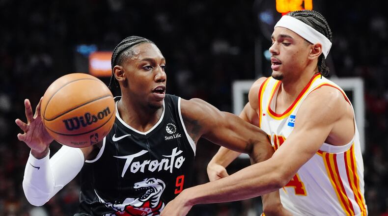 Toronto Raptors' RJ Barrett (9) drives past Atlanta Hawks' Asa Newell (14) during the first half of an NBA basketball game in Toronto, Saturday, Jan. 3, 2026. (Frank Gunn/The Canadian Press via AP)