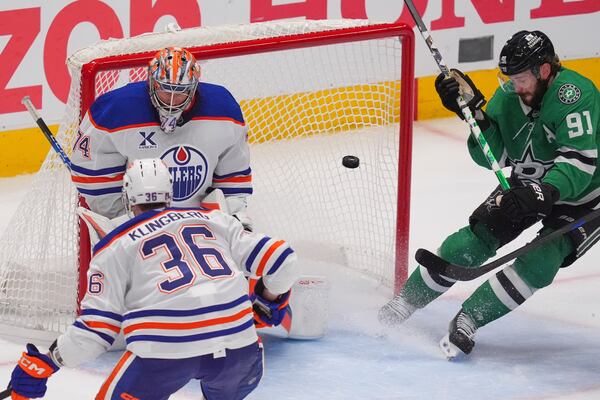 Edmonton Oilers goaltender Stuart Skinner (74) and defenseman John Klingberg (36) defend the goal against Dallas Stars center Tyler Seguin (91) during the third period in Game 1 of the Western Conference finals in the NHL hockey Stanley Cup playoffs Wednesday, May 21, 2025, in Dallas. (AP Photo/LM Otero)