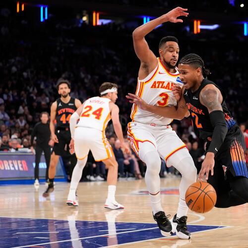 New York Knicks guard Miles McBride (2) drives past Atlanta Hawks guard CJ McCollum (3) during the first half in Game 2 of a first-round NBA playoffs basketball series, Monday, April 20, 2026, in New York. (AP Photo/Yuki Iwamura)