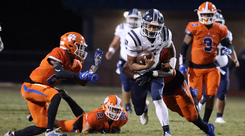 Marietta quarterback Tyler Hughes (7) is tackled by Parkview linebacker Nick Harden (6) in the second half.