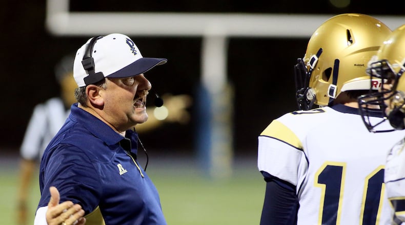 St. Pius' head coach Paul Standard talks to his players during a time out during first half action against the Marist War Eagles at Hughes Spalding Stadium in Atlanta on Friday, October 10, 2014. (Photo by Phil Skinner)