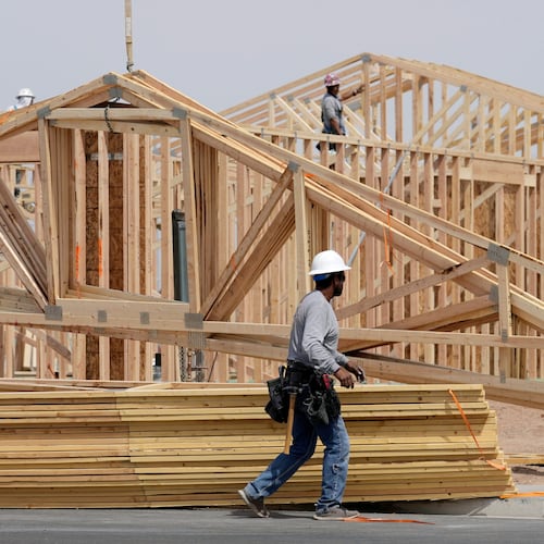 FILE - Construction workers install a lumber roof at a new home build Tuesday, April 1, 2025, in Laveen, Ariz. (AP Photo/Ross D. Franklin, File)