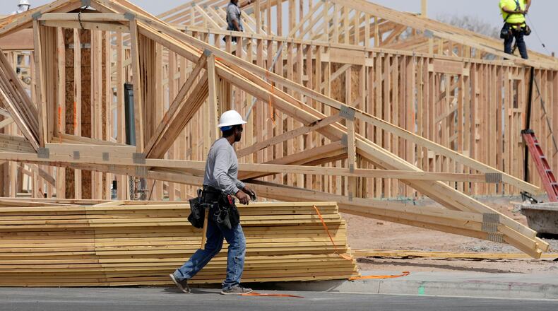 FILE - Construction workers install a lumber roof at a new home build Tuesday, April 1, 2025, in Laveen, Ariz. (AP Photo/Ross D. Franklin, File)