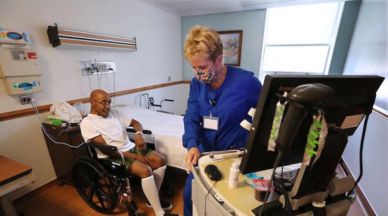 RN Debi Bartlett arrives for a medications administration for patient Rolando Heard in his room at Elbert Memorial Hospital in Elberton, which is pushing patient capacity on Thursday. (Curtis Compton / ccompton@ajc.com)