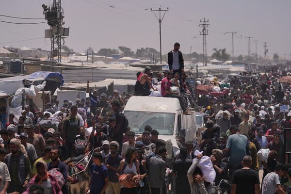 Palestinians carry bags containing food and humanitarian aid packages delivered by the Gaza Humanitarian Foundation, a U.S.-backed organization, in Rafah, southern Gaza Strip, Wednesday, June 11, 2025. (AP Photo/Abdel Kareem Hana)