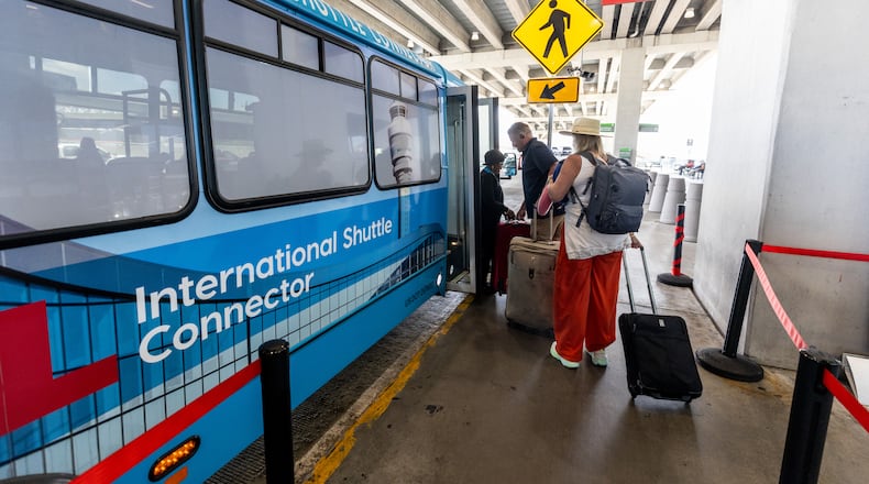 Passengers board the terminal-to-terminal shuttle at the international terminal Tuesday, Sept. 29, 2023.  (Steve Schaefer/steve.schaefer@ajc.com)