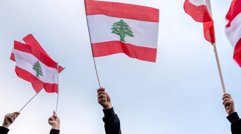 FILE - People wave Lebanese flags during a vigil, April 10, 2026, in Dearborn, Mich. (AP Photo/Julia Demaree Nikhinson, File)