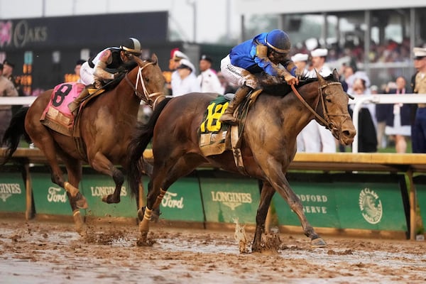 Sovereignty, right, ridden by Junior Alvarado, crosses the finish line to win the 151st running of the Kentucky Derby horse race followed by Journalism, ridden by Umberto Rispoli, at Churchill Downs Saturday, May 3, 2025, in Louisville, Ky. (AP Photo/Jeff Roberson)