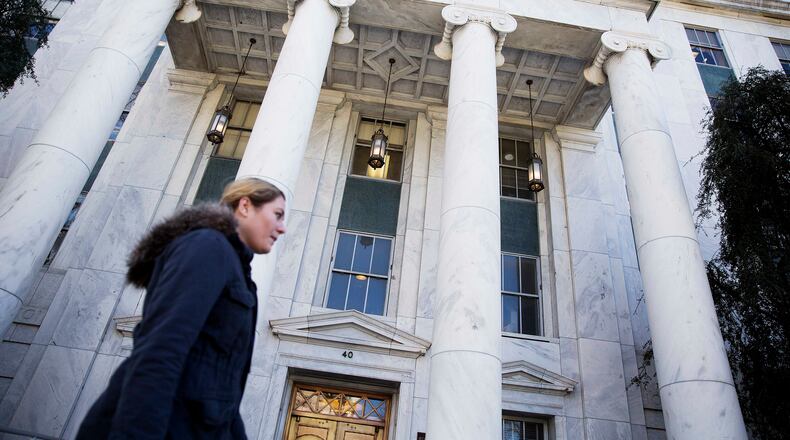 A pedestrian passes by the Georgia Supreme Court Thursday, Feb. 18, 2016, in Atlanta. The Georgia House has approved Gov. Nathan Deal's proposal to add two justices to the state's Supreme Court. Georgia's Constitution permits up to nine justices; state law currently provides for seven justices. The measure now will be reviewed by the state Senate. (AP Photo/David Goldman)