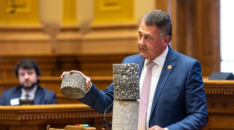 State Senate Majority Leader Steve Gooch, R-Dahlonega, holds a highway core sample while speaking in support of House Bill 189 in the state Senate on Thursday. The bill would temporarily allow some trucks to carry heavier loads on Georgia highways. (Arvin Temkar / arvin.temkar@ajc.com)