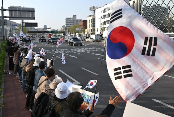 South Korea's ousted president Yoon Suk Yeol waves to supporters from his car as he leaves the official residence in Seoul, South Korea, Friday, April 11, 2025. ( Jung Yeon-je /Pool Photo via AP)