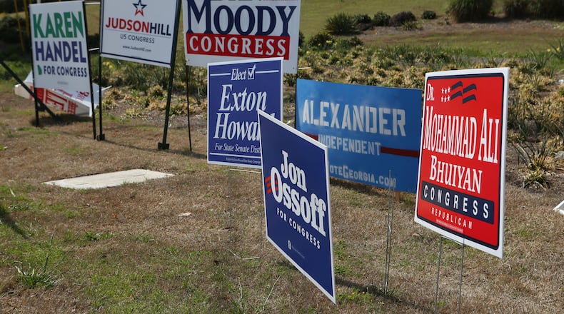 March 29, 2017, Atlanta, Georgia - Campaign signs posted in the ground at the intersection of Roswell Road and Abernathy Road let those driving by know who’s running in the Georgia 6th Congressional District special election in Sandy Springs, Georgia, on March 29, 2017. (HENRY TAYLOR / HENRY.TAYLOR@AJC.COM)