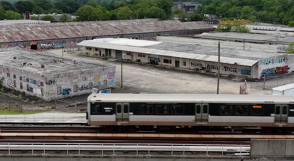Aerial photograph shows Marta train tracks in foreground and redevelop area of Murphy Crossing in background on Wednesday, April 24, 2024. Atlanta Mayor Andre Dickens announced Monday the largest expansion to MARTA’s train network in decades with four new stations expected to join the public transit system, including one at a large development project along the Beltline. One station will be at Murphy Crossing along the Beltline’s Westside Trail, meaning the popular mixed-use trail loop will soon be connected to heavy rail. The other three will be “infill” stations between existing stops, but the specific locations and how they will be funded were not provided. (Hyosub Shin / AJC)