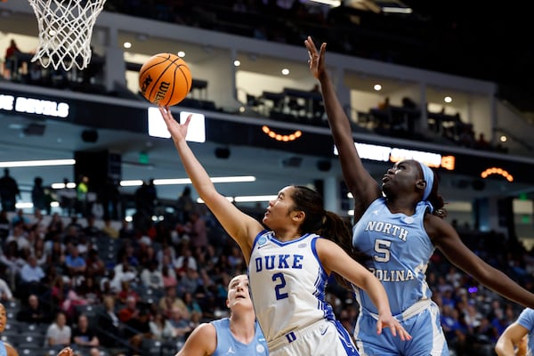 Duke guard Vanessa de Jesus (2) lays in a basket as North Carolina forward Maria Gakdeng (5) defends during the first half in the Sweet 16 of the NCAA college basketball tournament, Friday, March 28, 2025, in Birmingham, Ala. (AP Photo/Butch Dill)