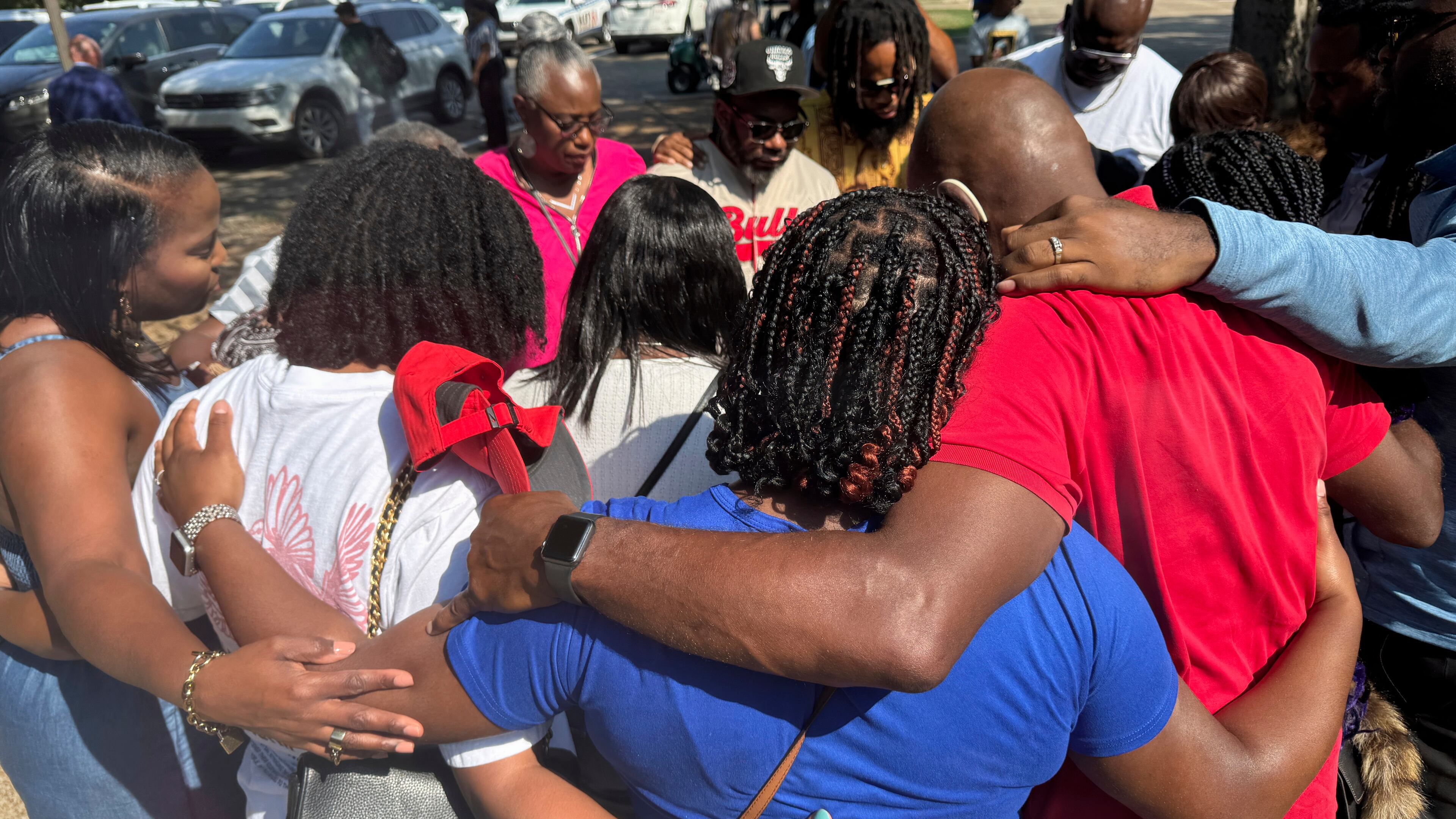 Friends and family of a deceased Delta State University student gather outside to pray after a law enforcement briefing, Wednesday, Sept. 17, 2025, in Cleveland, Miss. (AP Photo/Sophie Bates)