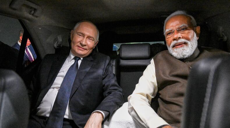 Russian President Vladimir Putin, and Indian Prime Minister Narendra Modi sit inside a limousine after arriving at the Palam Air Base in New Delhi, India, on Thursday, Dec. 4, 2025. (Grigory Sysoyev, Sputnik, Kremlin Pool Photo via AP)