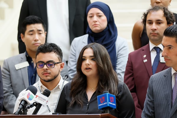 Katherine Guevara and her brother Oscar Guevara speak about their father during a news conference at the Georgia State Capitol on Tuesday. Mario Guevara, who has lawfully resided in the U.S. for more than 20 years, was taken into ICE custody June 18. (Miguel Martinez/AJC)