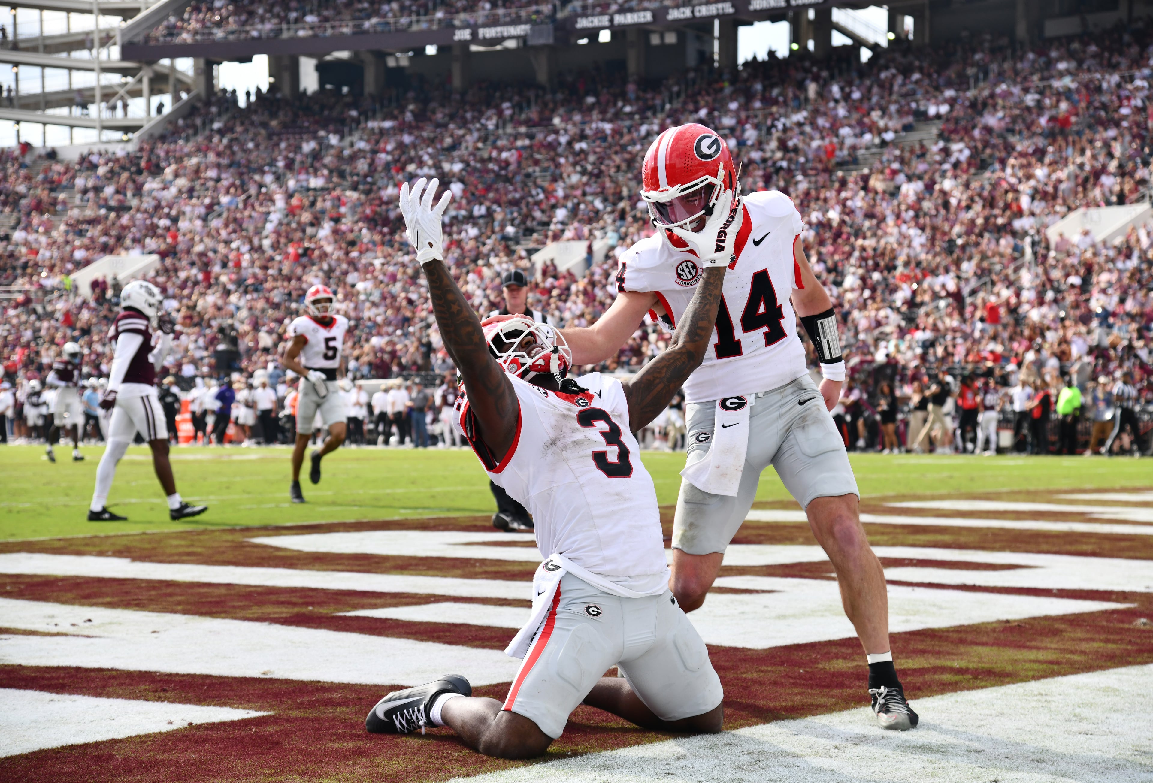 Georgia running back Nate Frazier (3) celebrates with Georgia quarterback Gunner Stockton (14) after scoring a touchdown during the second half in an NCAA football game at Davis Wade Stadium, Saturday, November 8, 2025, in Starkville, Mississippi. Georgia won 41-21 over Mississippi State. (Hyosub Shin / AJC)