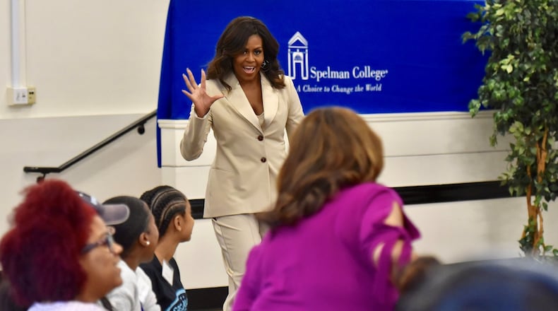Former first lady Michelle Obama waves at students as she enters a discussion at Spelman College on Saturday, May 11, 2019, about her memoir, “Becoming.” HYOSUB SHIN / HSHIN@AJC.COM
