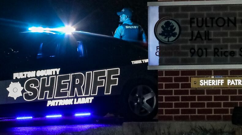 August 17, 2023 Atlanta: Sheriff deputies were at their posts at the Fulton County Jail located at 901 Rice Street NW in Atlanta on Thursday, Aug. 17, 2023 where President Trump and 18 others indicted earlier this week will surrender themselves. The Fulton County Jail, plagued with overcrowding and detainee deaths and under investigation by the U.S. Department of Justice, could make history as the first location where any U.S. president current or former gets a mug shot taken. Former President Donald Trump and the 18 others indicted this week in Fulton County will be booked there like any other pre-trial defendant, the sheriff’s office said. “At this point, based on guidance received from the District Attorney’s office and presiding judge, it is expected that all 19 defendants named in the indictment will be booked at the Rice Street Jail,” Fulton County Sheriff’s Office spokeswoman Natalie Ammons said in a statement. The 41-count, 98-page indictment says the 19 defendants “knowingly and willfully joined a conspiracy to unlawfully change the outcome of the election” in Georgia after Trump’s 2020 loss to President Joe Biden. District Attorney Fani Willis, who announced the indictment late Monday, on Wednesday afternoon proposed a March 4 trial date. She said the defendants have until noon Aug. 25 to surrender.  (John Spink / John.Spink@ajc.com)