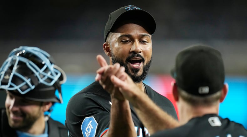Miami Marlins pitcher Sandy Alcantara, left, celebrates a win against the Arizona Diamondbacks with Marlins manager Clayton McCullough after a baseball game, Wednesday, Sept. 16, 2026, in Phoenix. (AP Photo/Ross D. Franklin)