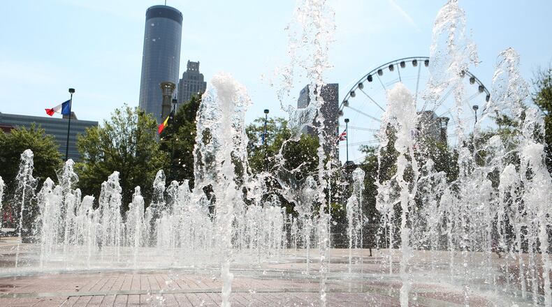 The “Fountain of Rings” in front of Atlanta skyscrapers and the SkyView Ferris wheel in Centennial Olympic Park. Atlanta was home to the games in 1996. EMILY JENKINS / EJENKINS@AJC.COM