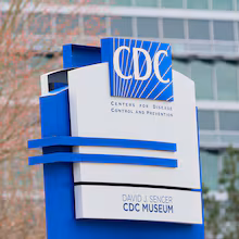 A sign with the CDC logo is displayed at the entrance to the agency's headquarters in Atlanta on March 2, 2025. (Miguel Martinez/AJC file)