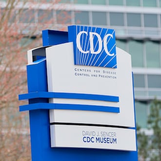 A sign with the CDC logo is displayed at the entrance to the agency's headquarters in Atlanta on March 2, 2025. (Miguel Martinez/AJC file)